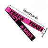 Pink and black adjustable lace headband for wigs and scarves shown diagonally with size measurements.
