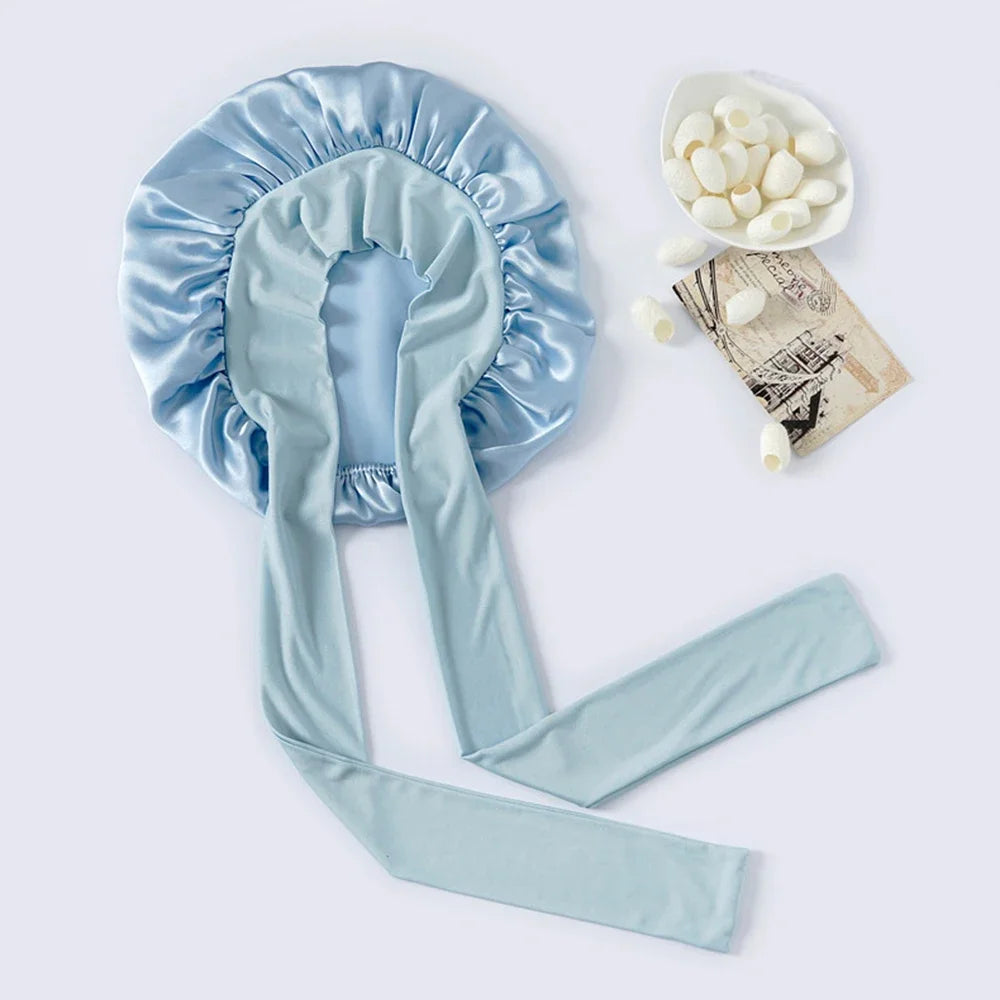 Light blue mulberry silk sleep bonnet with a matching silk tie and loose hair clips