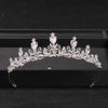 A sparkling crystal rhinestone bridal tiara headpiece displayed on a black surface.