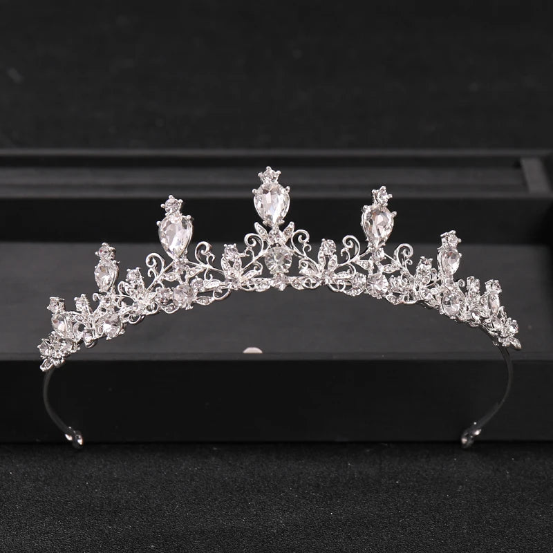 A sparkling crystal rhinestone bridal tiara headpiece displayed on a black surface.