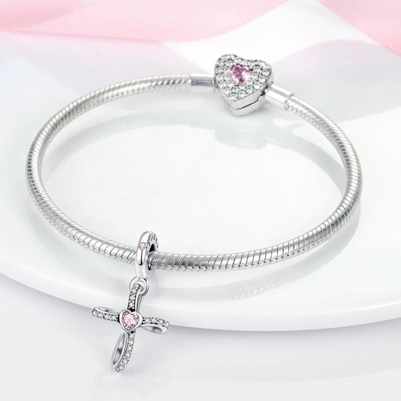 Sterling silver devil's eye charm bracelet with a heart pendant displayed on a white background.