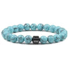 A bracelet made of light blue and green tiger eye lava map beads.
