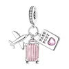 A sterling silver charm bracelet featuring a passport charm, a heart charm, and a plane charm.