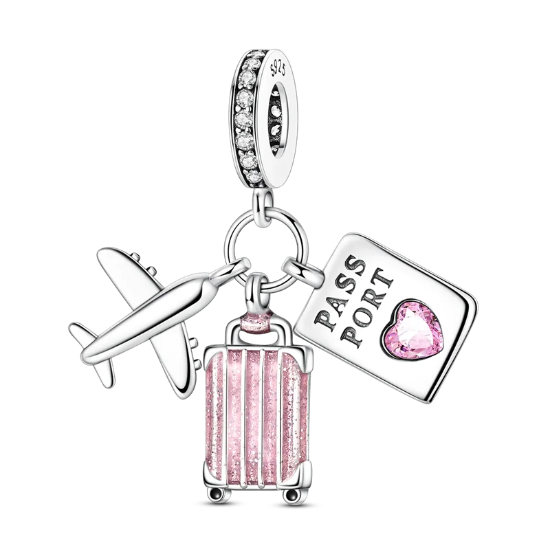 A sterling silver charm bracelet featuring a passport, a suitcase, and a diamond pendant.