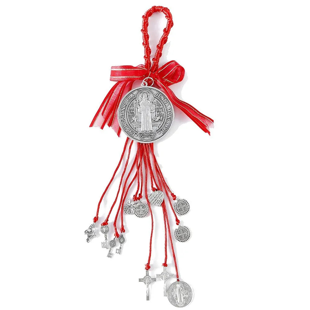 A red ribbon charm featuring a silver medallion depicting Saint Benedict.