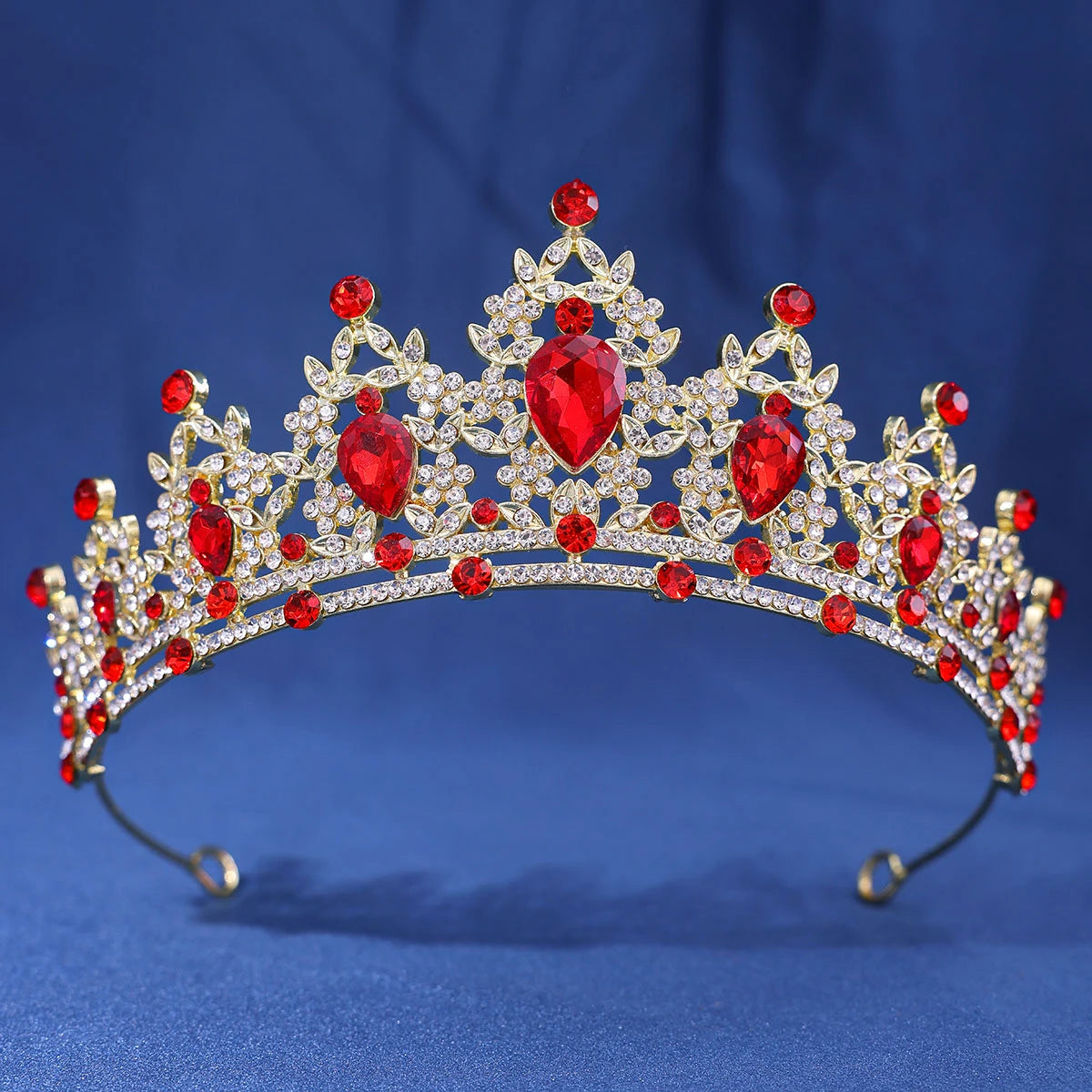 A sparkling gold crystal rhinestone tiara and headband set with red gemstones.