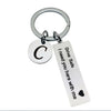 Silver keychain with a circular charm featuring the letter C and a tag that reads Drive Safe I need you here with me