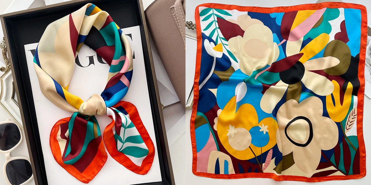 A floral print silk scarf featuring large flowers in shades of yellow, cream, and deep green against a dark background.