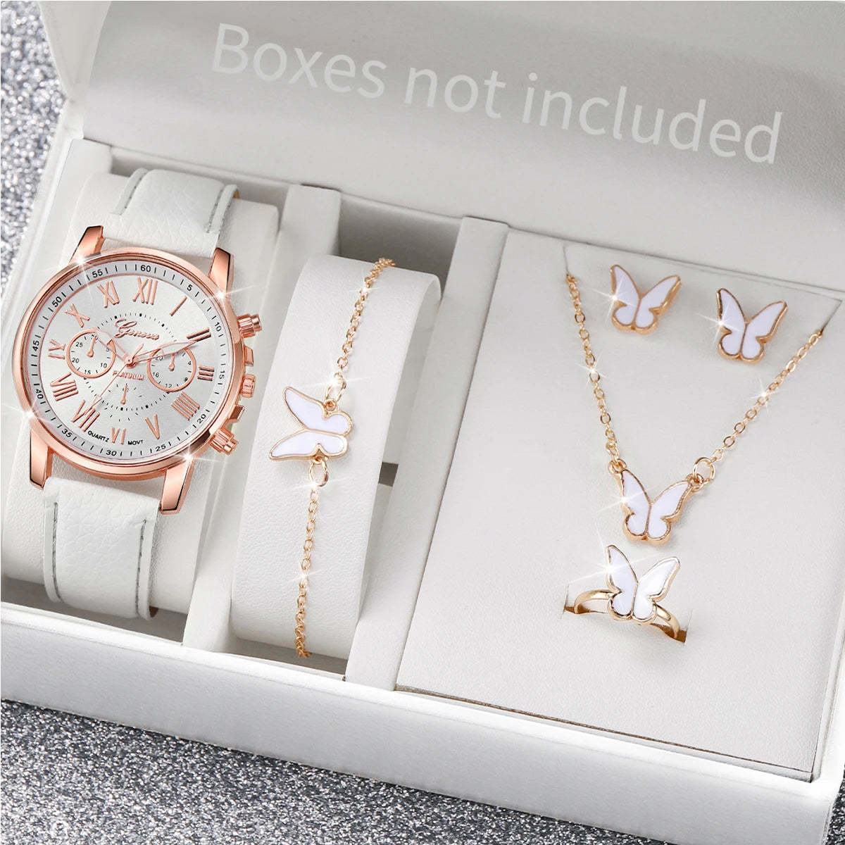 A silver-toned fashion quartz wristwatch with a leather strap is displayed inside an open white box.