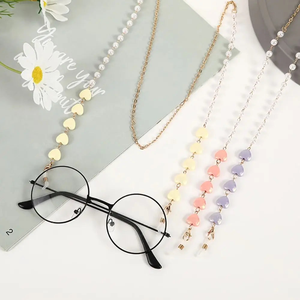 Multiple fashion pearl beaded eyewear chains displayed on a gray background.