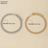 A pair of gold-plated minimalist Cuban link bracelets shown against a light background.