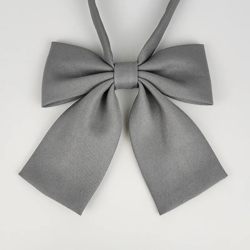 A gray striped butterfly ribbon tie set tied in a bow.