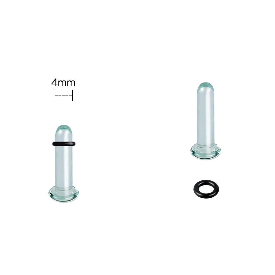 A glass ear stretching kit showing a cylindrical plug and a black ring.