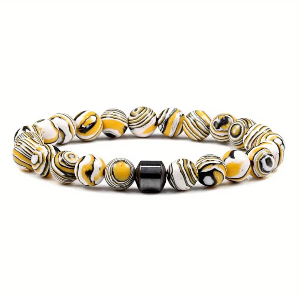 A bracelet made of tiger eye lava map beads with black and yellow swirling patterns.