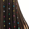 Close-up of dark brown hair braided with multicolor dreadlock rings.