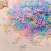 A pile of colorful disposable rubber hair ties in various shades of pink, blue, and yellow.