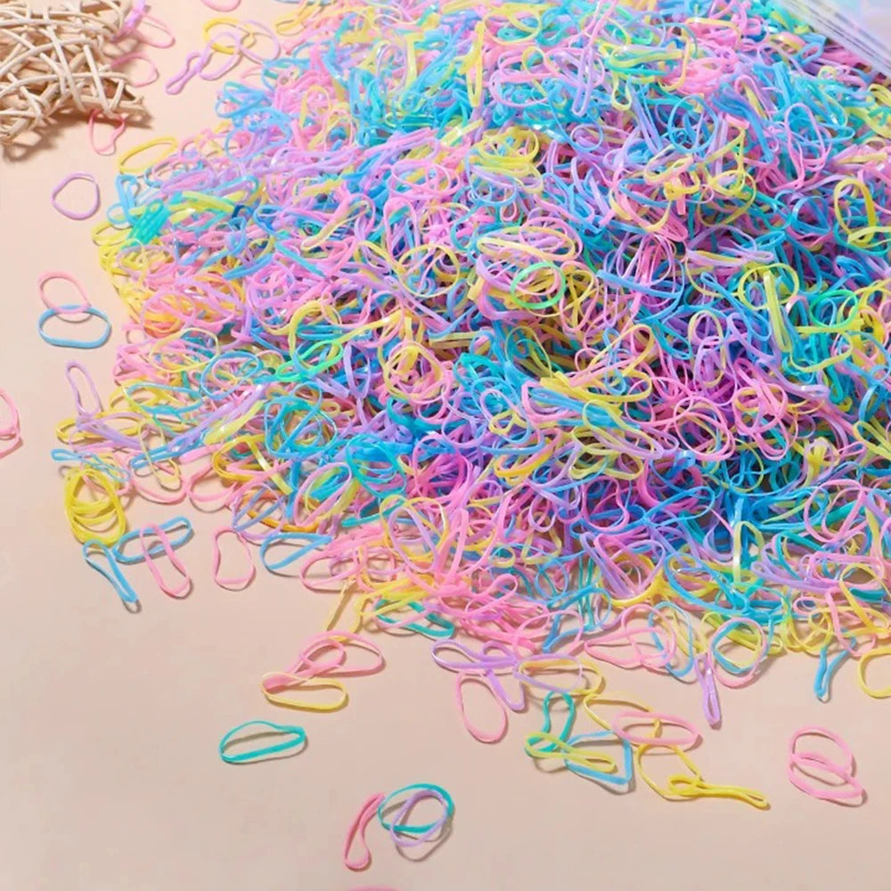 A pile of colorful disposable rubber hair ties in various shades of pink, blue, and yellow.
