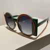 A pair of round double color fashion sunglasses with green frames and orange accents.