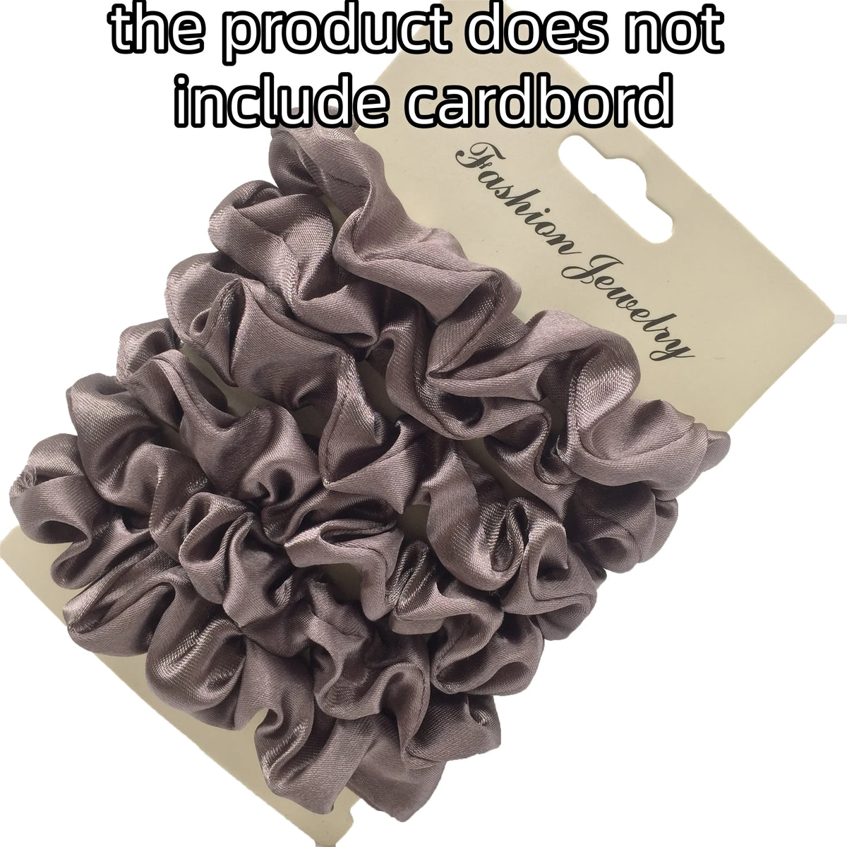 A pile of dark gray satin hair scrunchies displayed on a cardboard backing.