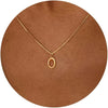 A delicate gold-plated stainless steel initial letter necklace with a simple circle charm displayed on a brown background.
