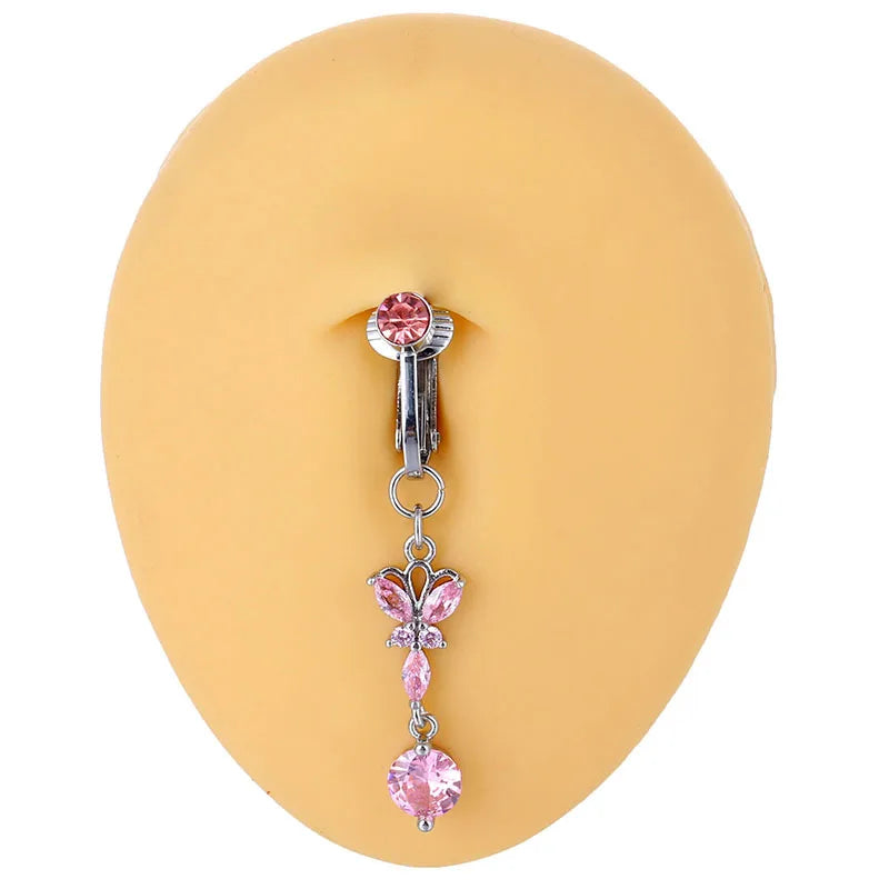 A silver belly button ring with a pink gemstone and a delicate chain.