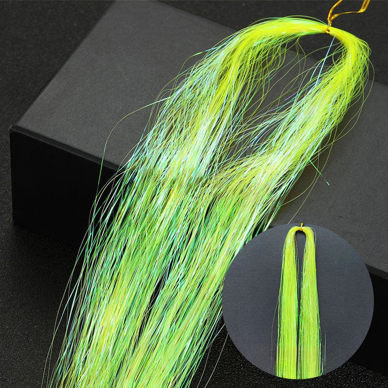 A long, bright lime green hair extension with fine strands is displayed against a dark background.
