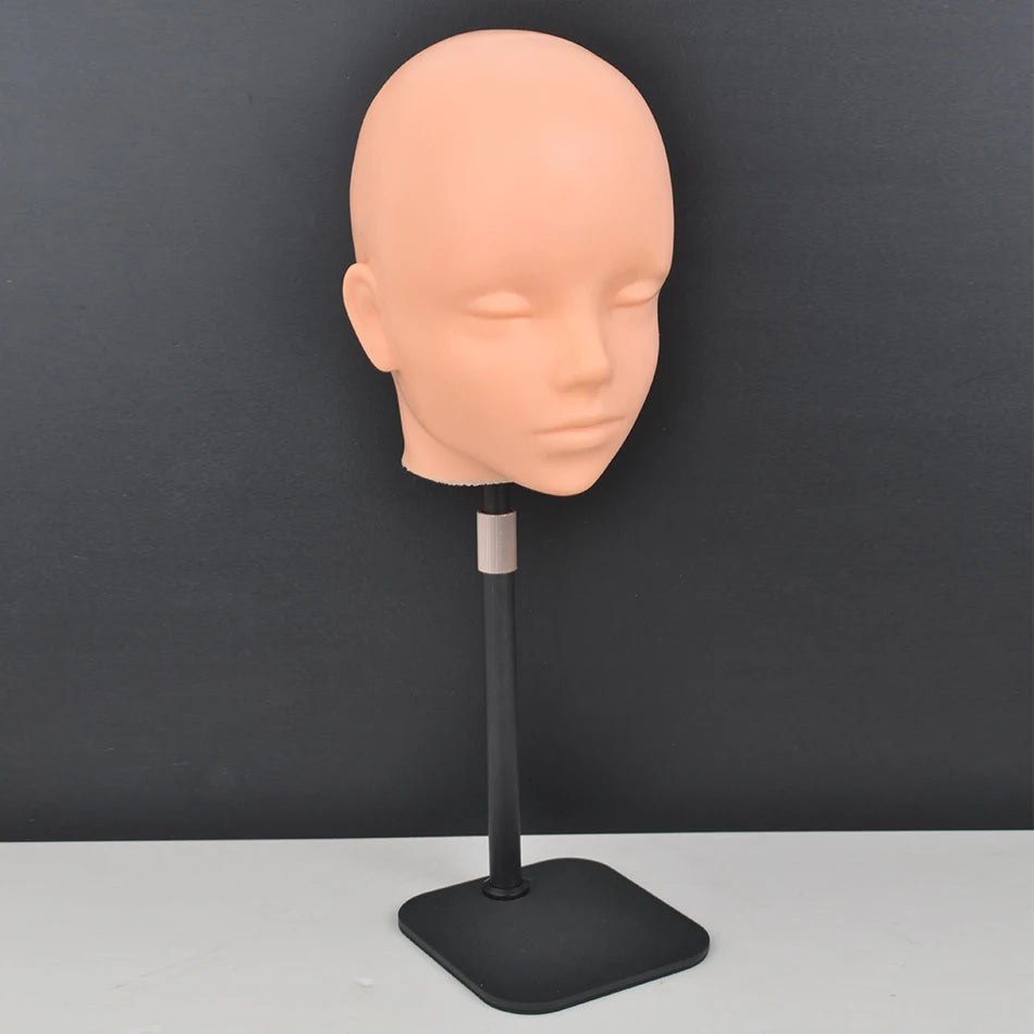 A light peach-colored professional mannequin head mounted on a black stand.