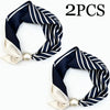 Two navy and white striped silk scarves with satin edges and pearl magnetic clasps