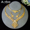 A luxury gold plated bridal jewelry set featuring intricate patterns and ornate designs displayed on a stand.