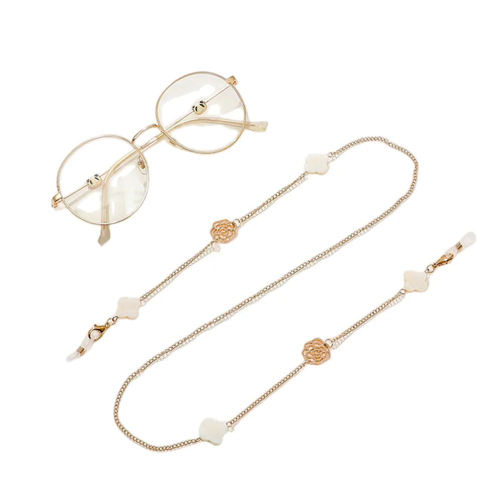 Elegant pearl metal eyeglasses chain with a delicate chain and round frame.