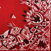 A close-up of a red textile featuring black and white geometric tribal patterns.