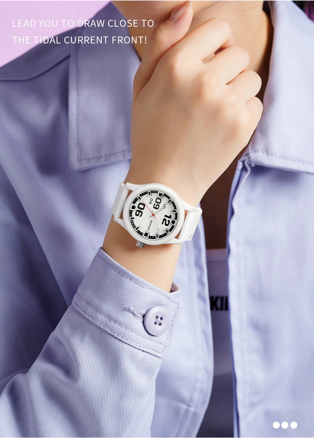 A close-up of a woman wearing a white quartz fashion watch with a silicone strap on her wrist, paired with a light purple shi