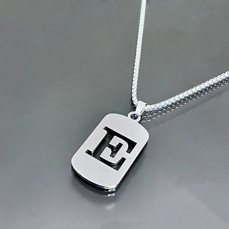 Silver stainless steel pendant necklace with an engraved capital letter E hanging from a chain