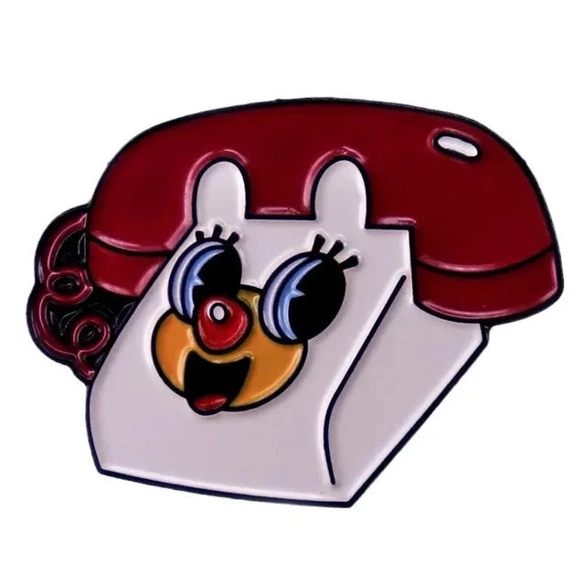 A retro cartoon enamel lapel pin featuring a white face with large black eyes and a red hair design.