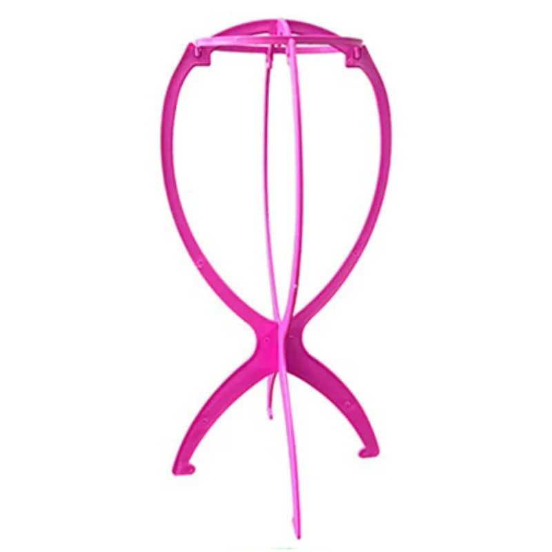 Soporte plegable portátil para pelucas rosa brillante con marco circular y brazos de soporte.