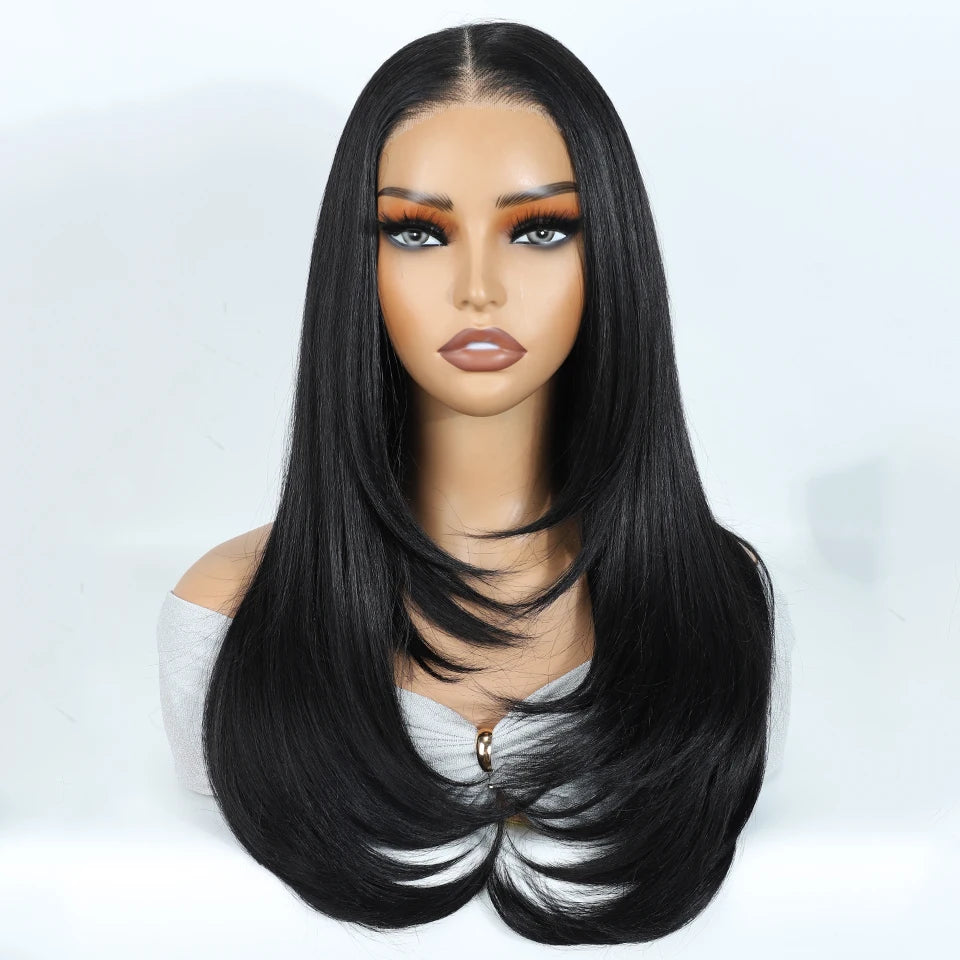 A model wearing a black layered straight synthetic lace front wig with striking orange-toned eyes.