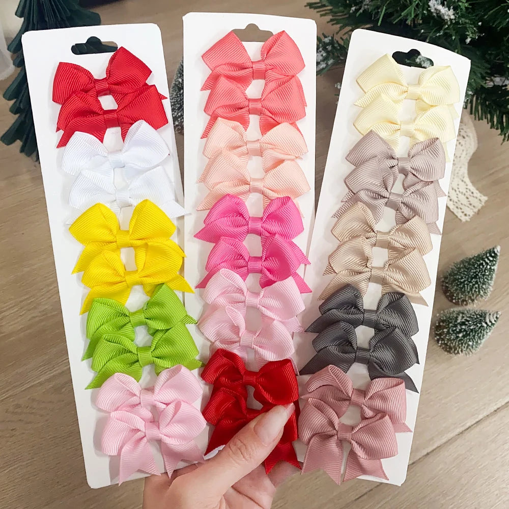 Colección de clips para el pelo en forma de lazo de colores sólidos infantiles en varios tonos como rojo, rosa, amarillo, ver