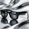 Black classic puffer square sunglasses resting on a reflective, wavy surface.