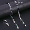 A close-up photo of a silver-toned Cuban link necklace with a 5mm chain, displayed on a black surface.