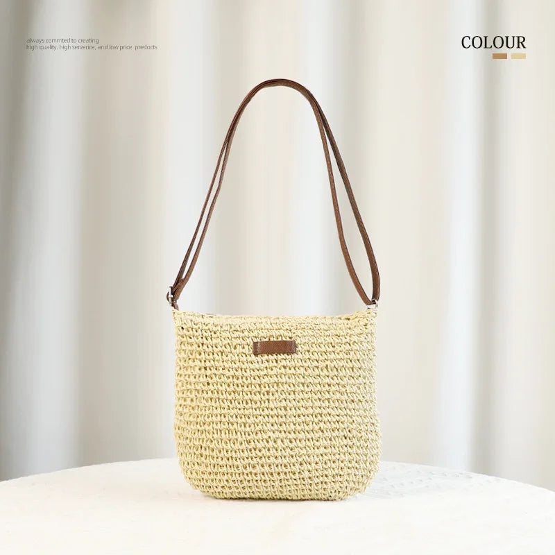 A light beige hand-woven straw visor hat displayed against a soft, light background.
