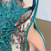 A close-up of a plus size African silk printed two-piece set featuring teal and brown patterns.