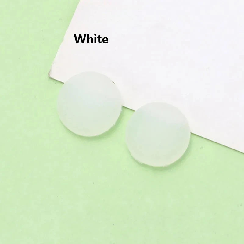 White silicone eyeglass grips placed on a white card.