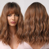 Close-up of a woman modeling a short wavy bob wig in a warm brown color