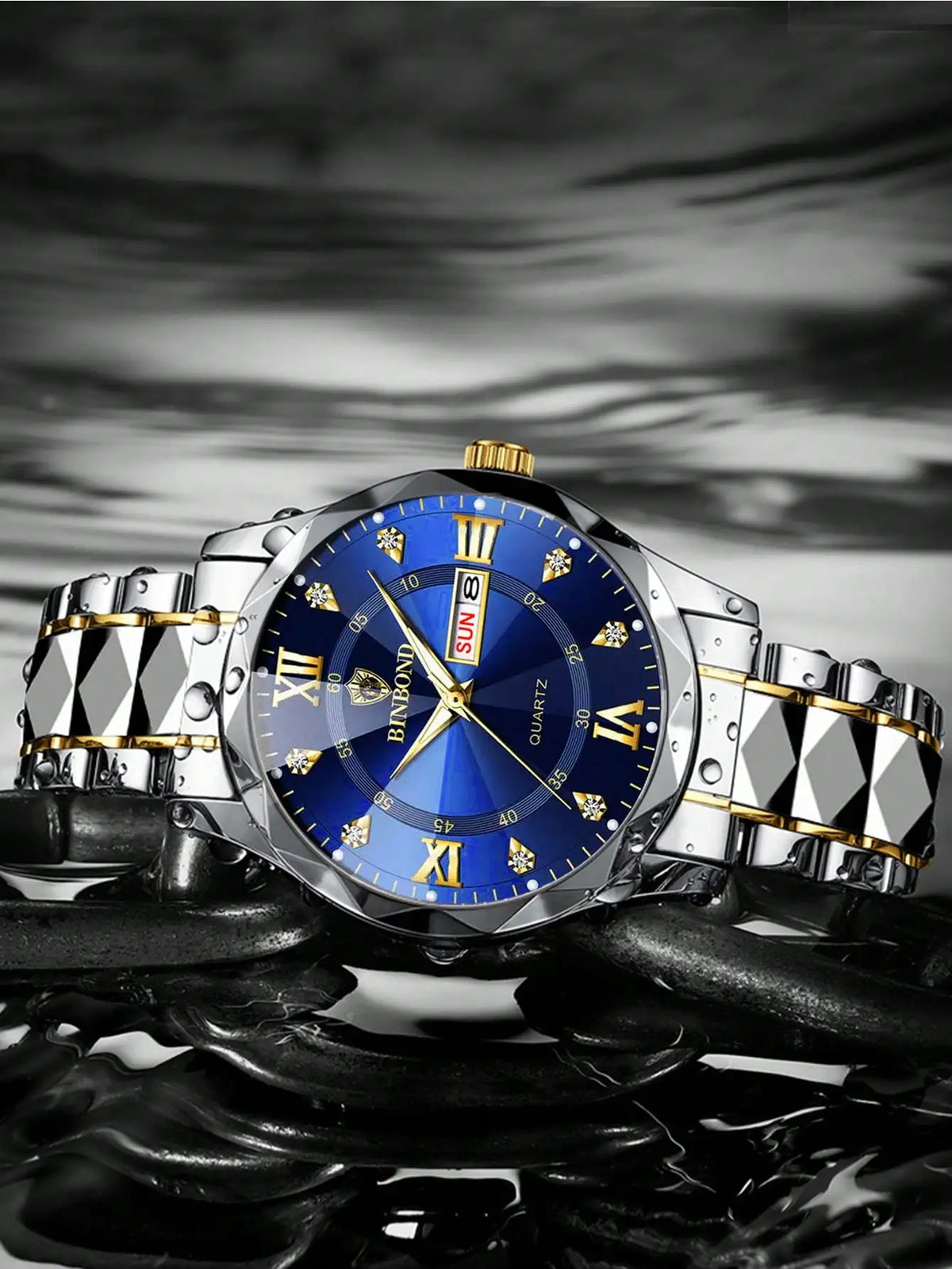 A close-up shot of a stainless steel watch with a blue dial and gold accents resting on a dark, reflective surface.