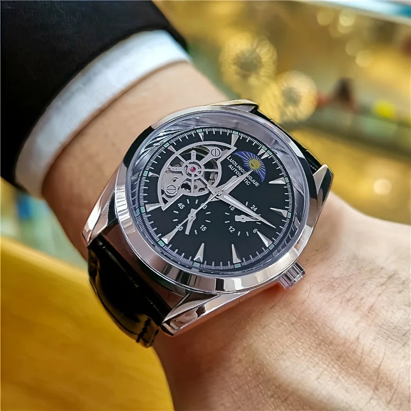 A close-up of a silver luxury automatic mechanical men's wristwatch worn on a wrist.