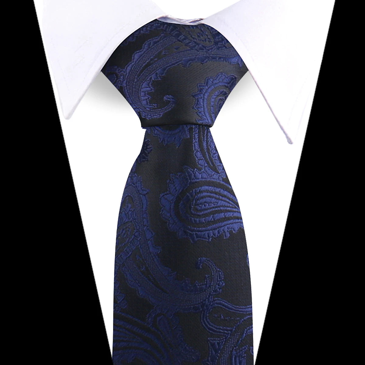 A dark blue paisley silk necktie with floral patterns shown against a white shirt.