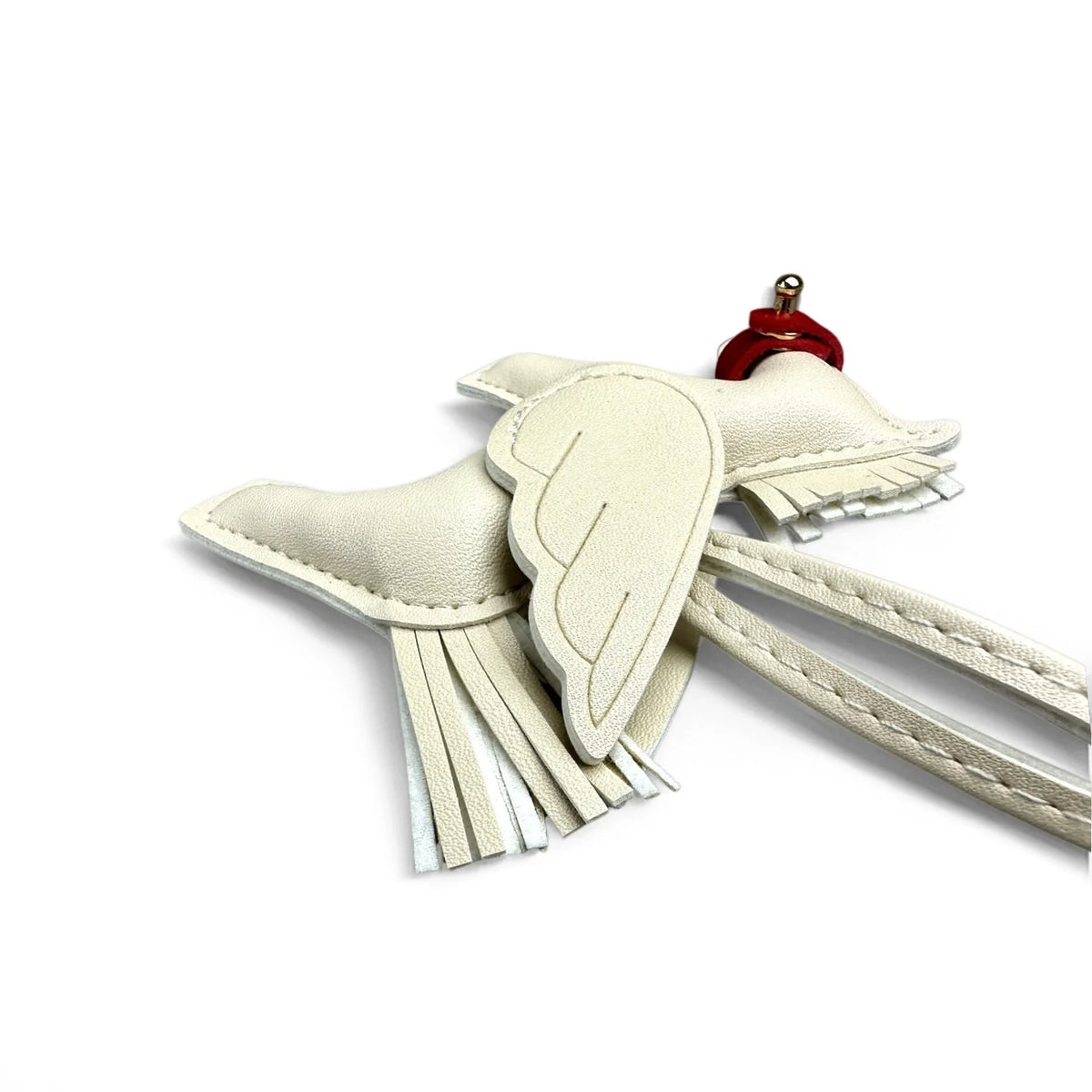 A light beige elegant winged pony keychain with fabric wings and a red metal clasp.