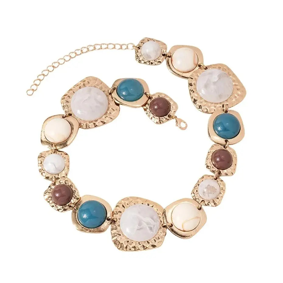 Boho gold plated resin statement choker necklace featuring round white and blue gemstone beads