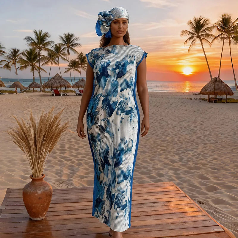A plus size model wearing a blue and white patterned dress standing on a wooden deck with a tropical sunset background.