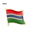 A lapel pin badge featuring horizontal stripes of red, blue, and green on a gold-colored metal background.